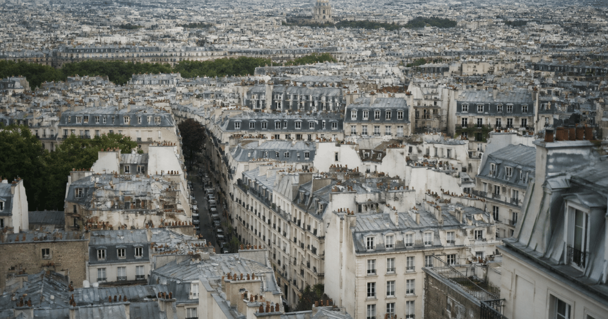 Aerial view of Paris cityscape showing dense urban buildings.