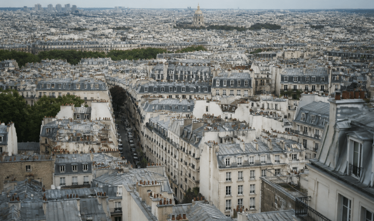 Aerial view of Paris cityscape showing dense urban buildings.