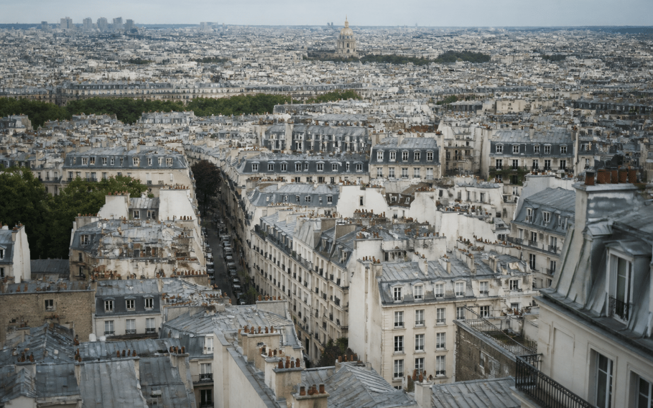 Aerial view of Paris cityscape showing dense urban buildings.