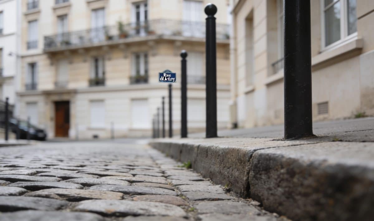 Rue pavée d'Antony avec immeuble résidentiel en arrière-plan